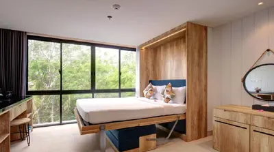 a bedroom with a bed and a large window at Esco Luxe Benoa in Nusa Dua
