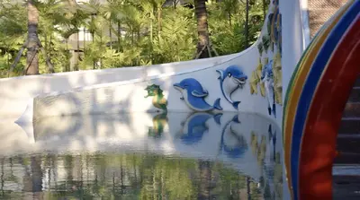 a wall with a painting of birds on it at Esco Luxe Benoa in Nusa Dua
