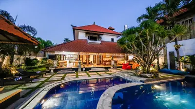 a house with a swimming pool in front of a house at Sandy Shores Bali in Seminyak