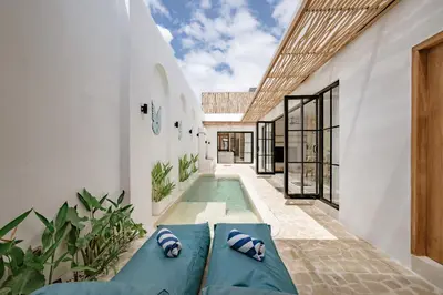 a swimming pool in the middle of a house at Soft Opening! Villa Lumière 1 Seminyak in Seminyak