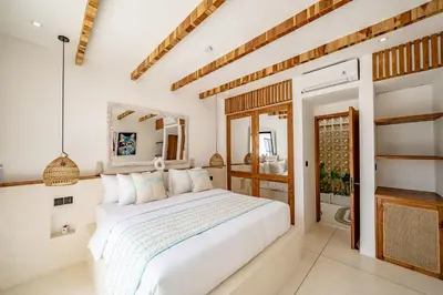 a bedroom with a white bed and a mirror at Soft Opening! Villa Lumière 1 Seminyak in Seminyak