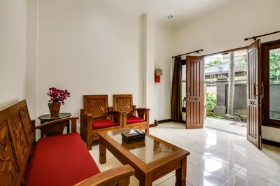 a living room with a couch and a table at Gracia Apartment Seminyak Managed by Manara in Seminyak
