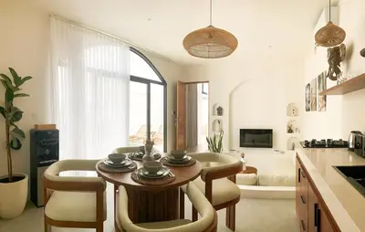a kitchen and living room with a table and chairs at Cozy and Chic Villa with Private Pool at Balangan in Jimbaran
