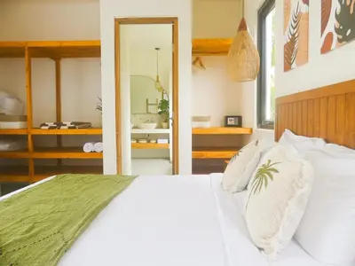 a bedroom with a white bed and a mirror at Cozy and Chic Villa with Private Pool at Balangan in Jimbaran