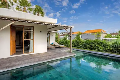 a villa with a swimming pool and a house at Villa Rice - Amazing Rice-Field VIEW 3BR Villa 9px Next To Canggu in Kerobokan