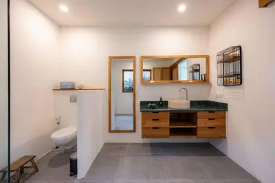 a bathroom with a sink and a toilet at Villa Rice - Amazing Rice-Field VIEW 3BR Villa 9px Next To Canggu in Kerobokan