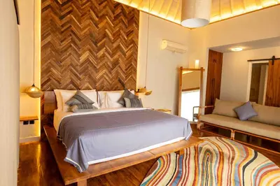 a bedroom with a large bed and a couch at Tuluscolivingseminyakvilla1 in Seminyak