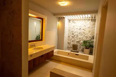 a bathroom with a sink and a tub and a mirror at Tuluscolivingseminyakvilla1 in Seminyak