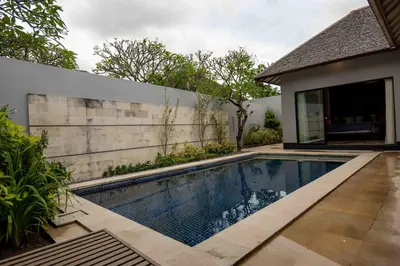 a swimming pool in the backyard of a house at Tuluscolivingseminyakvilla1 in Seminyak