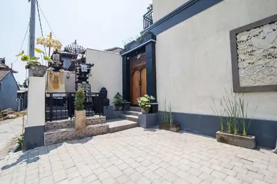 a building with a wooden door with potted plants on it at The Lavana Villa De Kerobokan in Seminyak