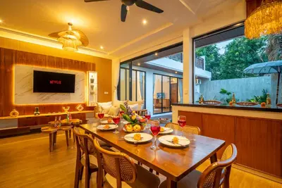 a dining room with a table and chairs at Villa Bella Wilson 4 in Seminyak