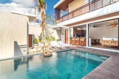 a swimming pool in the backyard of a house at Villa Bella Wilson 4 in Seminyak