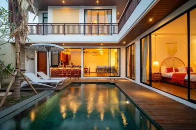 an indoor pool in a house with a bedroom at Villa Bella Wilson 4 in Seminyak