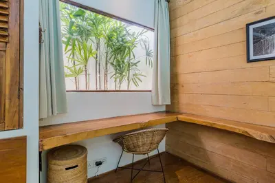 a window in a room with a bench and a basket at Villa Ubuntu 3BR Pool Ricefield Family&Friends group near Canggu in Kerobokan
