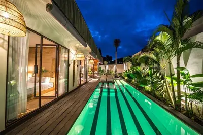 a swimming pool in the middle of a house at Villa Ubuntu 3BR Pool Ricefield Family&Friends group near Canggu in Kerobokan