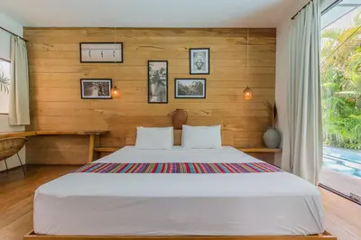 a bedroom with a large white bed in a room at Villa Ubuntu 3BR Pool Ricefield Family&Friends group near Canggu in Kerobokan