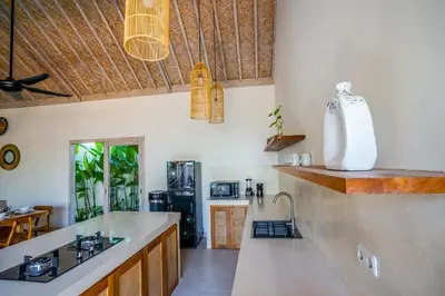 a kitchen with a sink and a counter top at Villa Vaimala 4BR Pool Tropical Home Seminyak in Seminyak