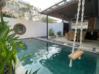 a swimming pool with a swing in a backyard at Casa Nakoa 2BR With Private Pool in Nusa Dua