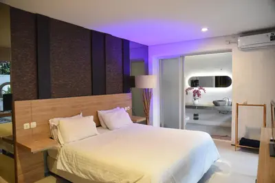 a bedroom with a large bed with purple lighting at Casa Nakoa 2BR With Private Pool in Nusa Dua