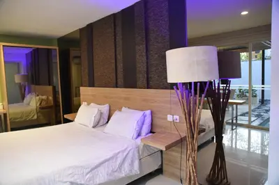 a bedroom with a large bed and a lamp at Casa Nakoa 2BR With Private Pool in Nusa Dua
