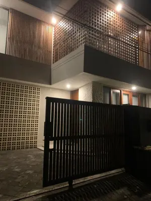 a building with a black gate and a staircase at Villa Mirana in Seminyak