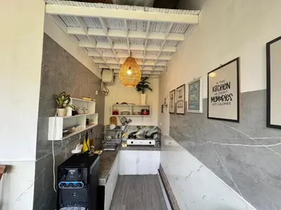 a kitchen with a counter and a stove in it at Kubu Betel Home Stay in Canggu