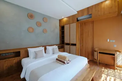 a bedroom with a large white bed in a room at Anama Villa Kerobokan in Seminyak