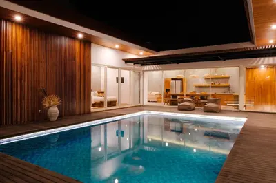 a swimming pool in a house with a living room at Anama Villa Kerobokan in Seminyak