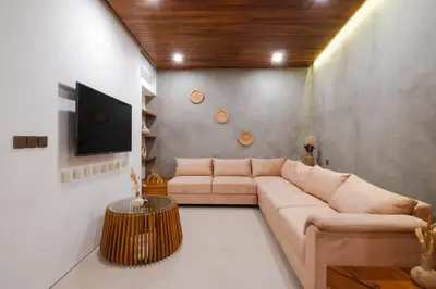 a living room with a couch and a table at Anama Villa Kerobokan in Seminyak