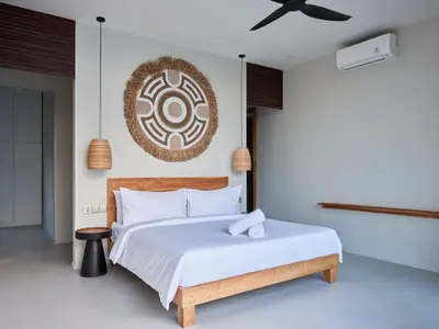 a bedroom with a bed and a ceiling fan at Villa Papaya Luxurious4bd Umalas in Canggu