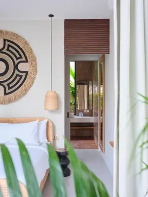 a bedroom with a bed and a view of a bathroom at Villa Papaya Luxurious4bd Umalas in Canggu