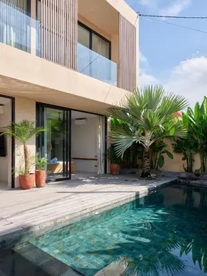 a house with a swimming pool next to a building at Villa Papaya Luxurious4bd Umalas in Canggu