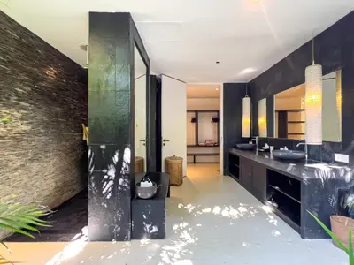 a bathroom with black walls and a sink at Luxurious 5Br Retreat in Umalas in Canggu