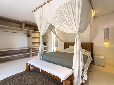 a bedroom with a bed with a canopy at Luxurious 5Br Retreat in Umalas in Canggu