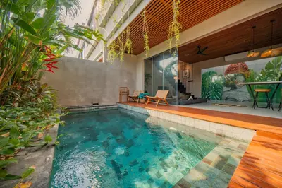 a swimming pool in the middle of a house at Villa Cek Ombak 2 Canggu in Canggu