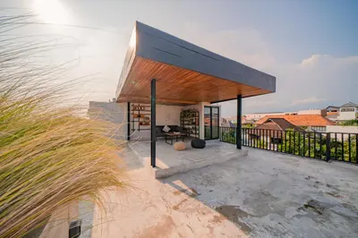 a modern house with a black roof at Villa Cek Ombak 2 Canggu in Canggu