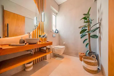 a bathroom with a sink and a toilet and a mirror at Villa Cek Ombak 2 Canggu in Canggu