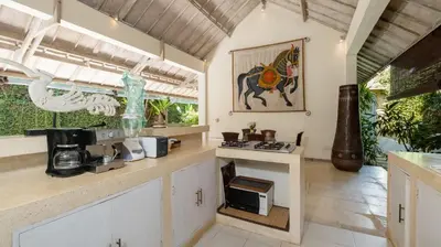 a kitchen with a counter top with a microwave at Gembira Villa Seminyak in Canggu