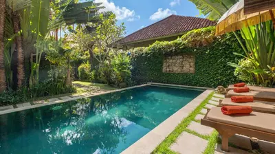 an image of a swimming pool in front of a house at Gembira Villa Seminyak in Canggu