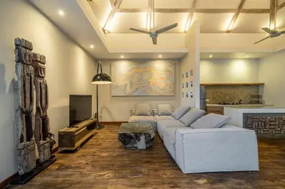 a living room with a couch and a tv at Le Chloe Villa Seminyak in Seminyak