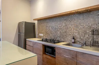 a kitchen with a sink and a stainless steel refrigerator at Le Chloe Villa Seminyak in Seminyak