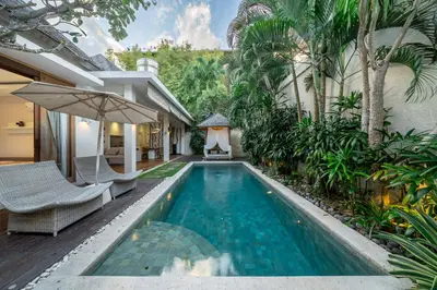 a swimming pool in the middle of a house at Le Chloe Villa Seminyak in Seminyak