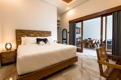 a bedroom with a bed with a stuffed animal on it at Villa Sakura III Seminyak in Seminyak