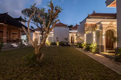 a house with a tree in the yard at Villa Sakura III Seminyak in Seminyak
