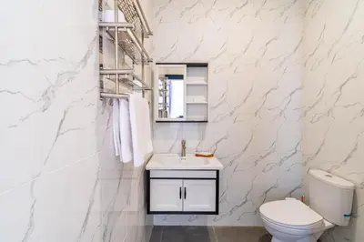 a white bathroom with a toilet and a sink at Villa Litan Seminyak - 3 Bedroom Villa in Seminyak