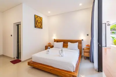 a bedroom with a bed with two white towels on it at Villa Litan Seminyak - 3 Bedroom Villa in Seminyak