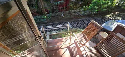 two chairs sitting outside of a house with a door at The Palmana Courtyard Jayakarta Residence 4 in Seminyak