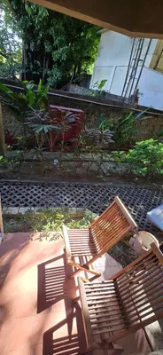two wooden benches sitting on a patio at The Palmana Courtyard Jayakarta Residence 4 in Seminyak