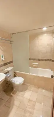 a bathroom with a toilet and a sink and a tub at The Palmana Courtyard Jayakarta Residence 6 in Seminyak