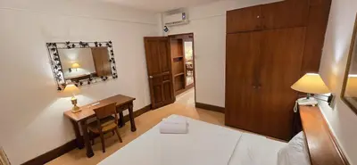 a hotel room with a desk and a mirror at The Palmana Courtyard Jayakarta Residence 6 in Seminyak
